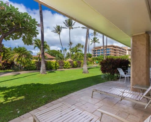 Patio with loungers and garden views.